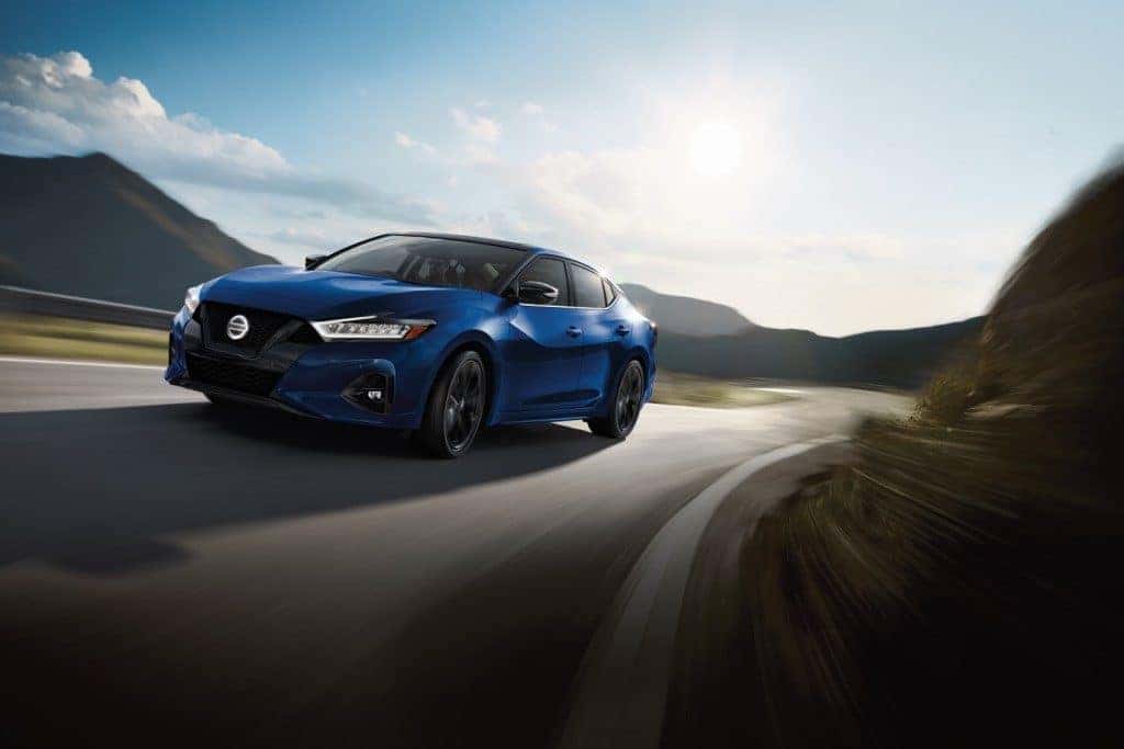 2021 Nissan Maxima blue driving down dark highway