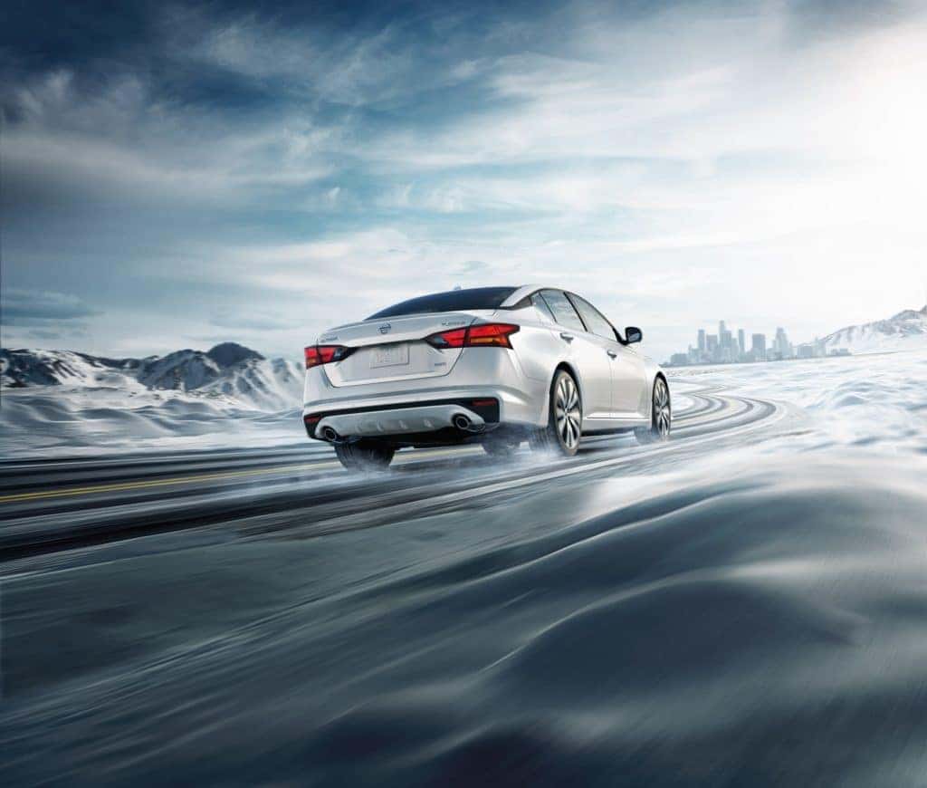 2022 Nissan Altima AWD white driving through snow