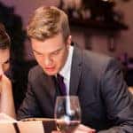 Smiling couple reading menu and choosing meal