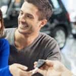 couple getting keys to a new car