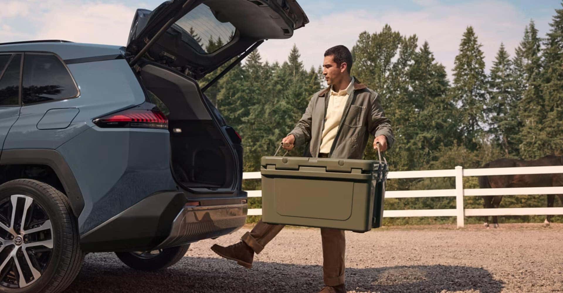 Toyota-RAV4--man-loading-box-into-trunk