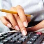 Person Entering Numbers in Calculator