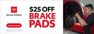 $25 off brake pads schedule service toyota service center is written on top of a white background with a photograph of a toyota technician working on brakes next to it.