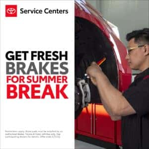 Get fresh brakes for summer break at toyota service centers written on a white background with a photograph of a toyota technician working on brakes on the right side.