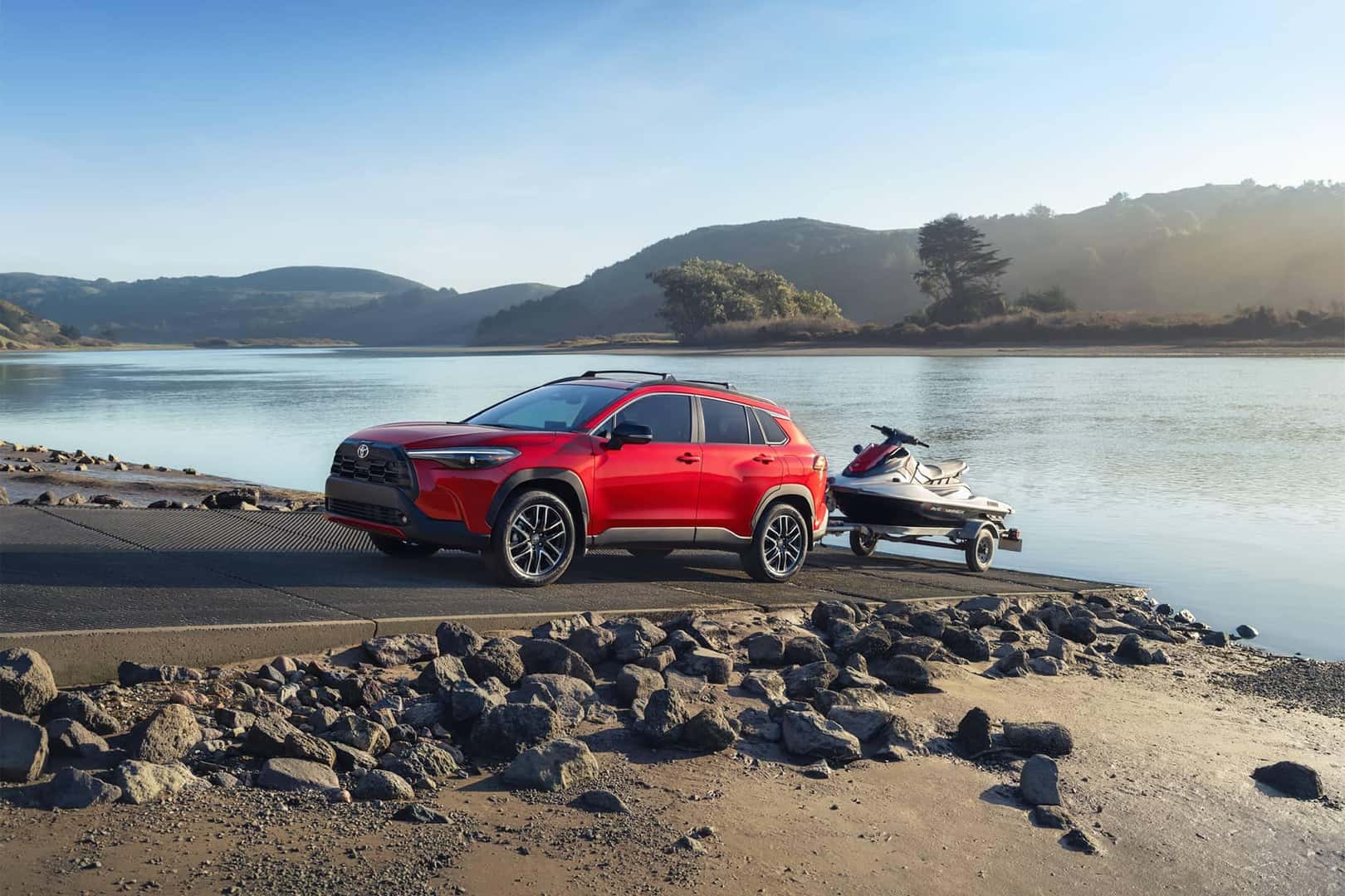red toyota vehicle trailing a jet ski