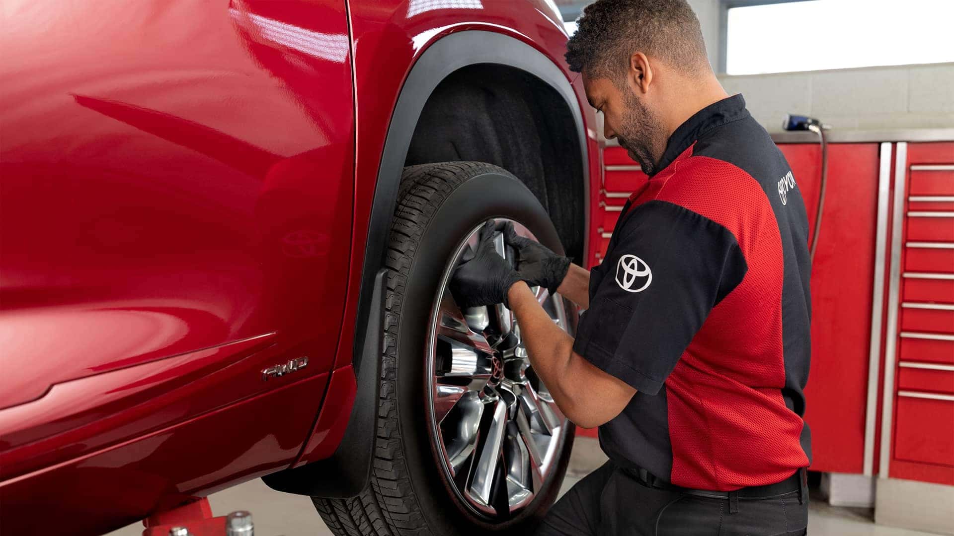 toyota service technician working on tire