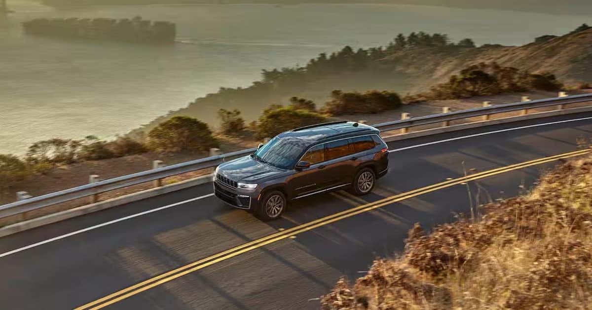 A 2026 Jeep Grand Cherokee on a curved road