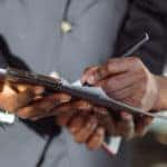 Woman signing Lexus lease or financing documents