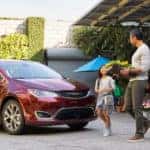 Family walking towards Chrysler Pacifica minivan