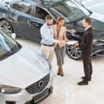 Couple signing documents for new car