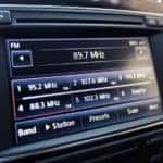 Infotainment car screen with radio station on