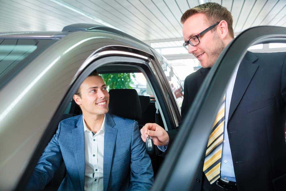 Customer leasing a car from auto salesman