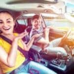 Couple Driving By Lake