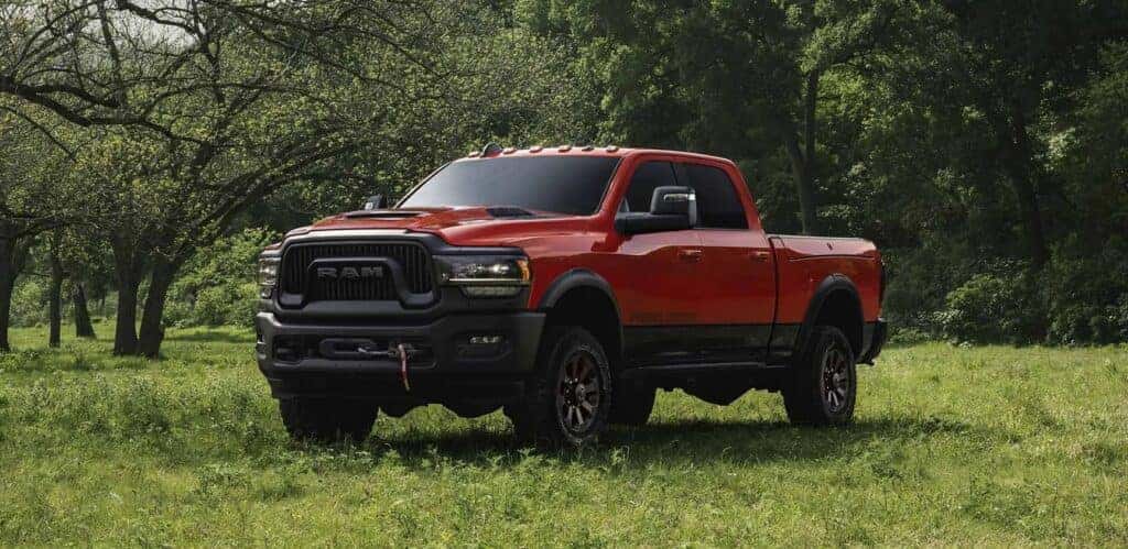 The 2023 RAM 2500, a new RAM truck for sale, parked among greenery